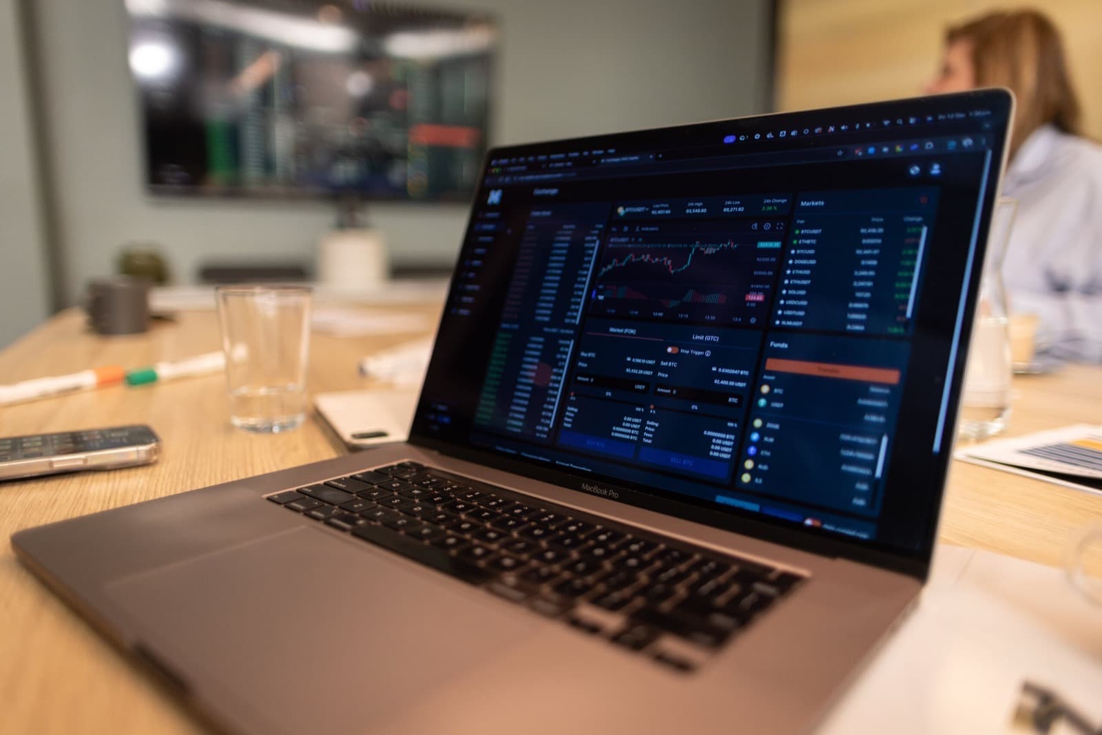 A market dashboard on a laptop in a meeting room.